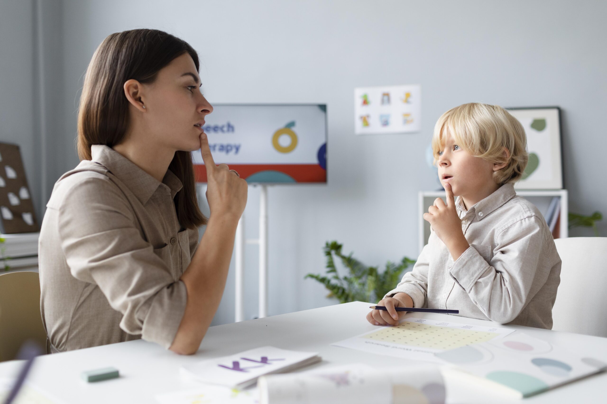 woman-doing-speech-therapy-with-little-blonde-boy