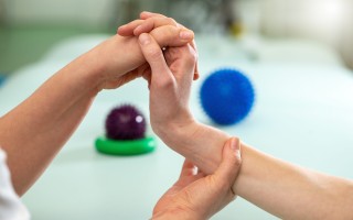 Doctor exercising and making rehabilitation with patient wrist